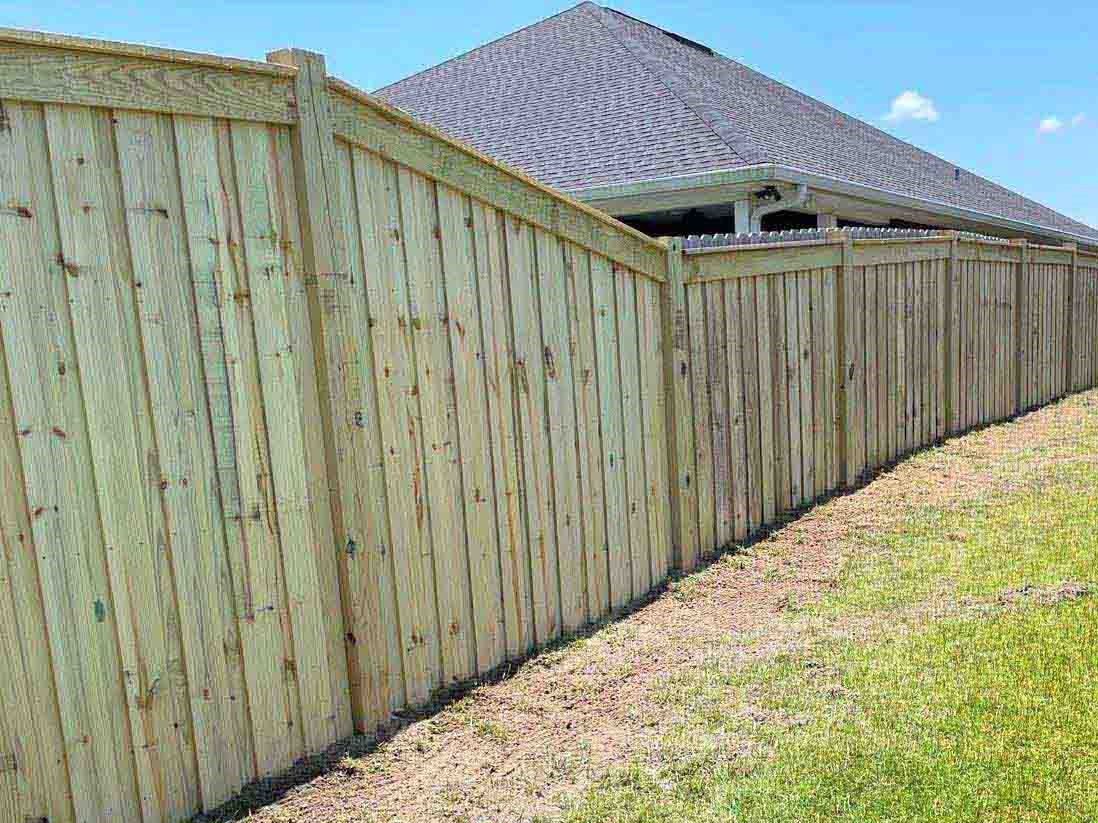 Photo of a wood fence installation on uneven ground in Panama City Florida
